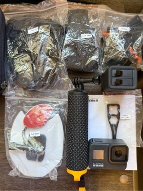 GoPro Action Camera with Black Grip and Yellow Strap
